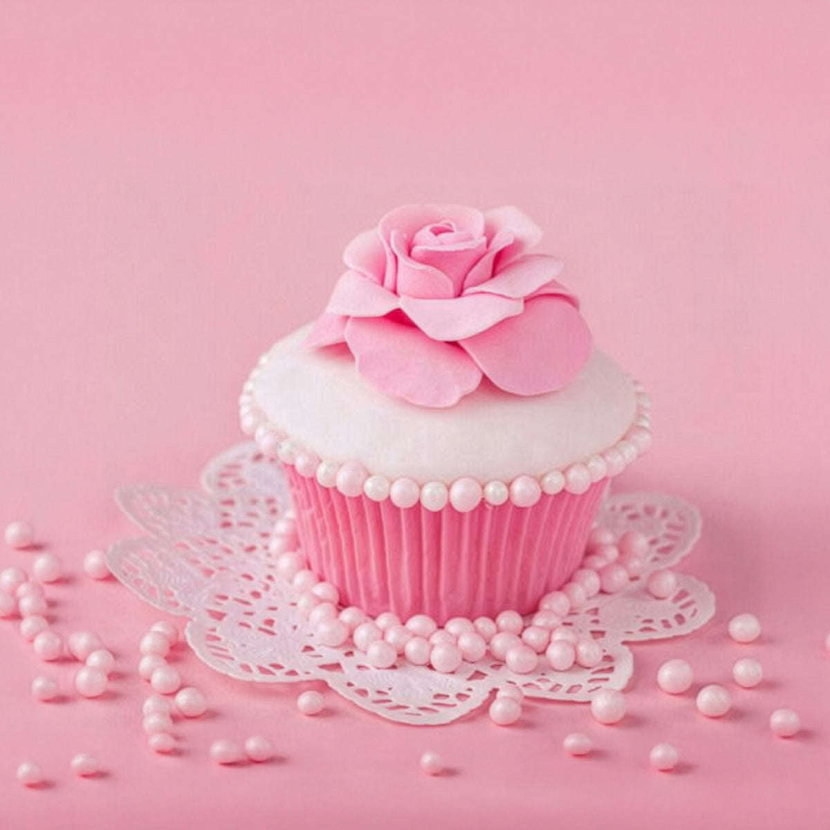 Buttercream Frosting fragrance artwork with a pink and white cupcake topped by a pink rose and surrounded by pearl decorations.