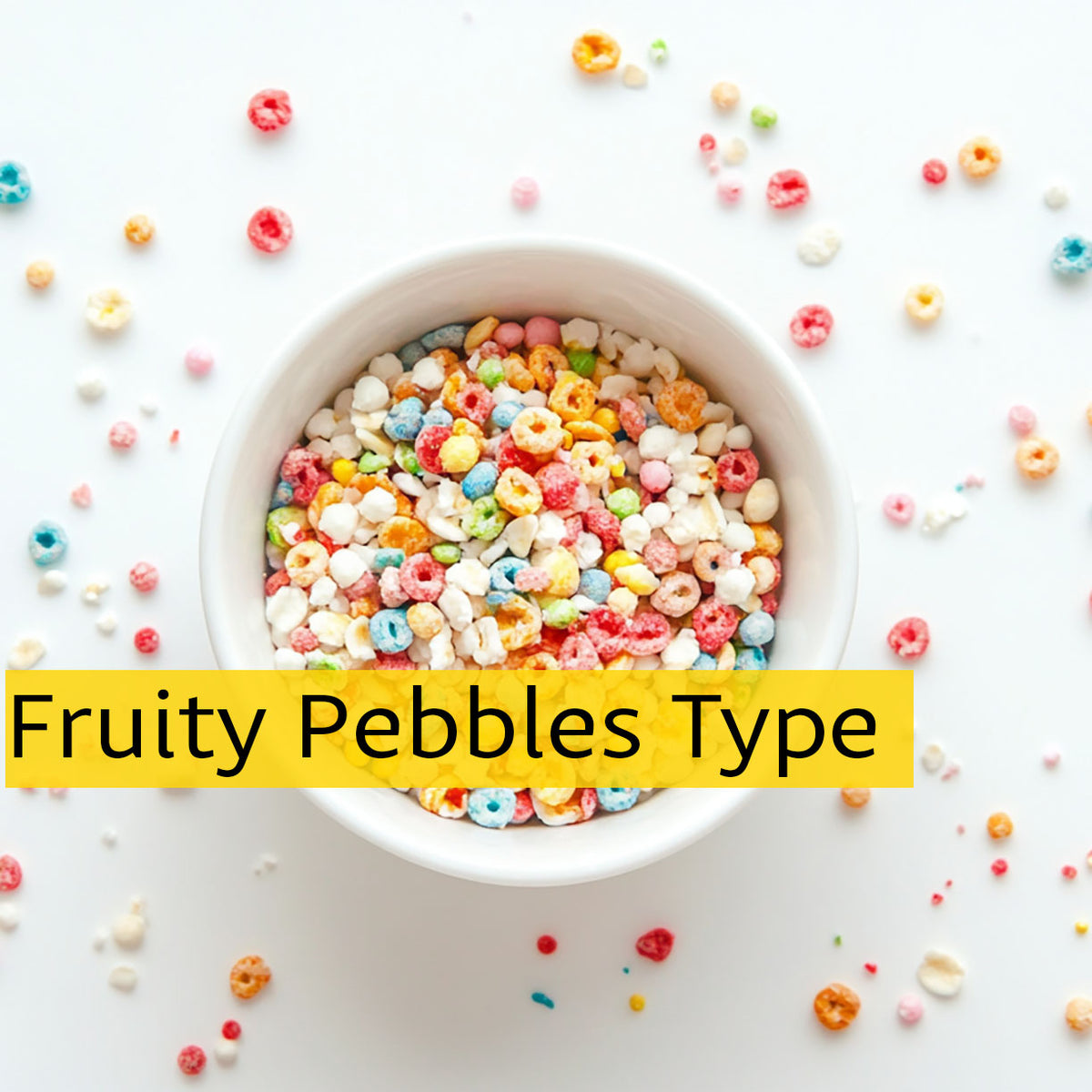 Overhead bowl of colorful fruity cereal with scattered cereal pieces on a white background.